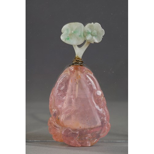 Tourmaline snuff bottle carved in the shape of fruit with foliage and flowers. Jadeite stopper carved in the shape of flowers ...